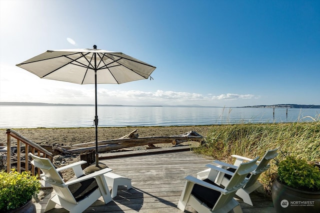 wooden terrace featuring a water view