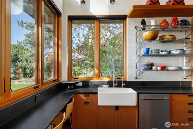 bar featuring a wealth of natural light, backsplash, dishwasher, and a sink