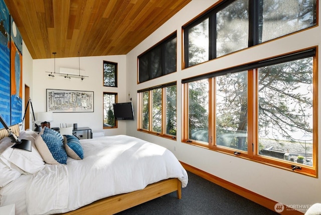 bedroom with baseboards, high vaulted ceiling, wood ceiling, and carpet flooring