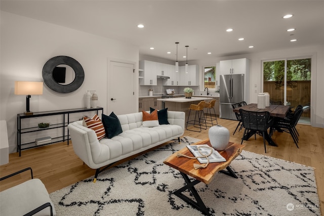 living room featuring light hardwood / wood-style floors and sink