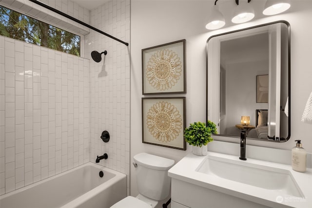 full bathroom featuring toilet, vanity, and tiled shower / bath