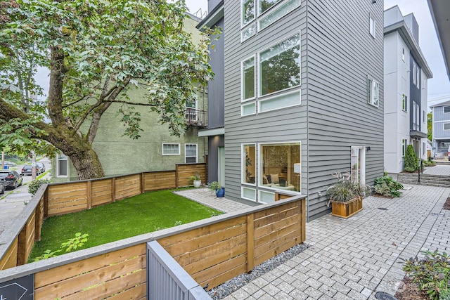 back of property with a patio and a balcony