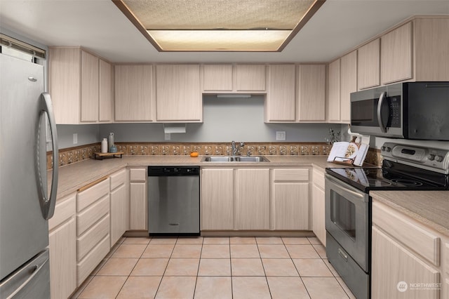 kitchen featuring sink, light brown cabinets, and stainless steel appliances