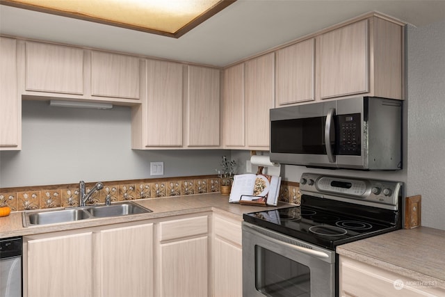 kitchen featuring light brown cabinetry, appliances with stainless steel finishes, and sink