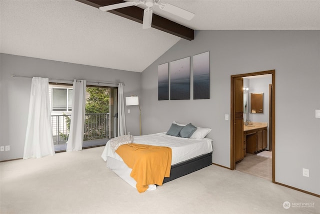 carpeted bedroom featuring ceiling fan, a textured ceiling, access to exterior, ensuite bath, and lofted ceiling with beams