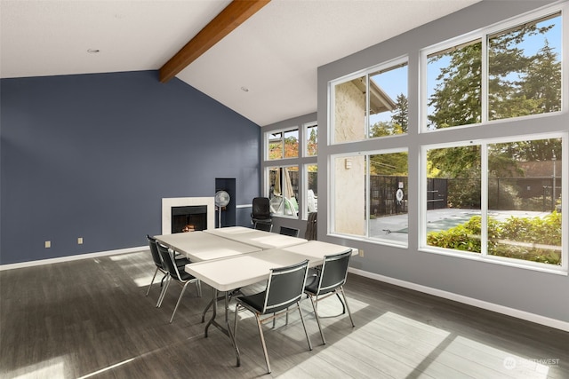 sunroom / solarium featuring vaulted ceiling with beams and a healthy amount of sunlight