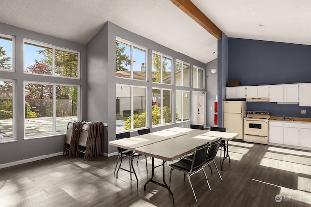 dining room with beam ceiling, high vaulted ceiling, sink, and dark hardwood / wood-style flooring