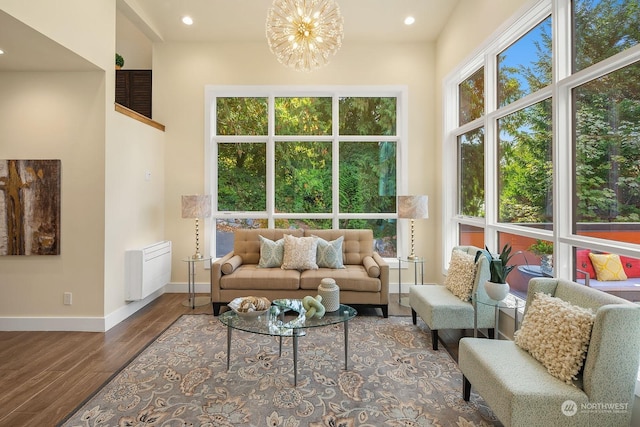 interior space featuring baseboards, a notable chandelier, recessed lighting, wood finished floors, and radiator heating unit