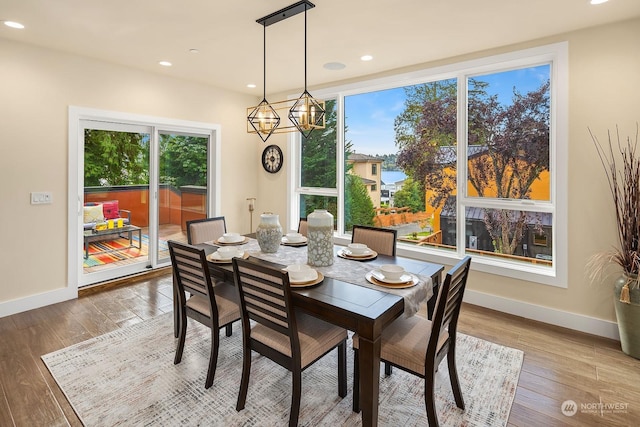dining area featuring recessed lighting, plenty of natural light, baseboards, and hardwood / wood-style floors