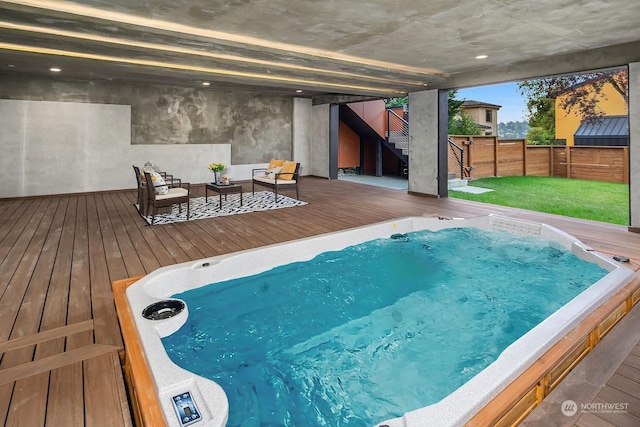 view of pool with hot tub deck surround