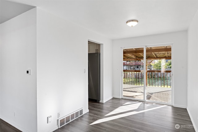 empty room featuring dark wood-type flooring