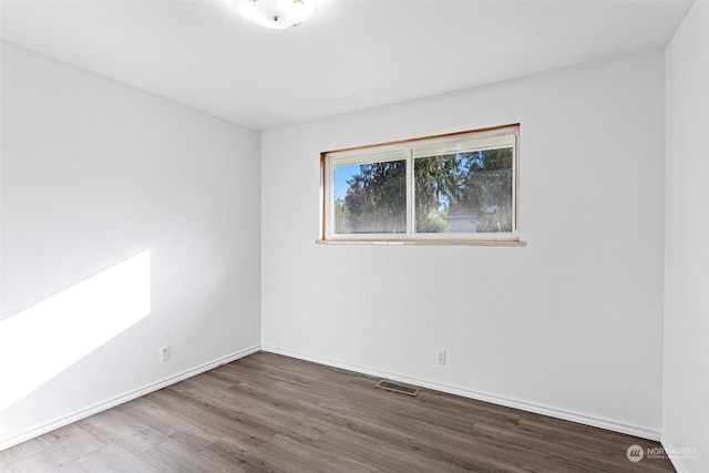 unfurnished room with hardwood / wood-style floors