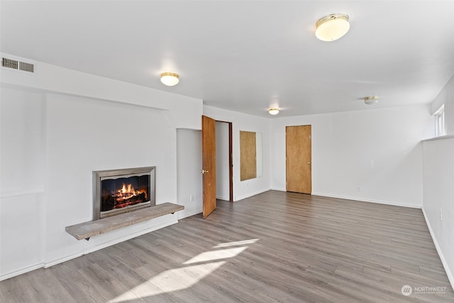 unfurnished living room featuring wood-type flooring