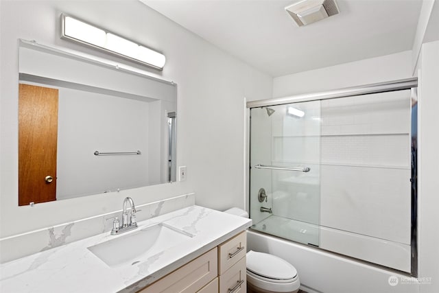 full bathroom with shower / bath combination with glass door, vanity, and toilet