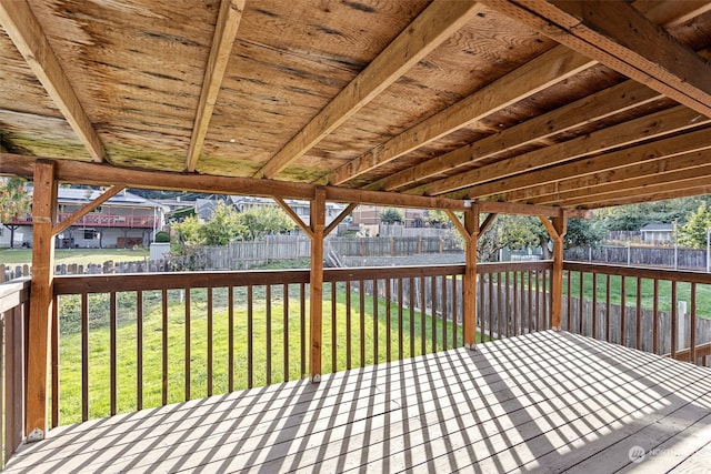 wooden terrace featuring a lawn