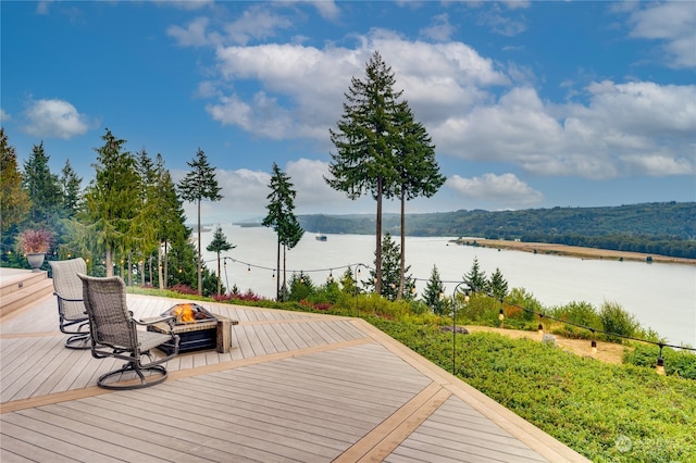 wooden terrace featuring a water view