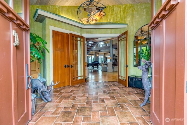 foyer entrance featuring french doors and lofted ceiling