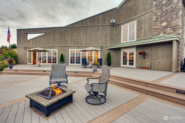 deck with french doors and a fire pit