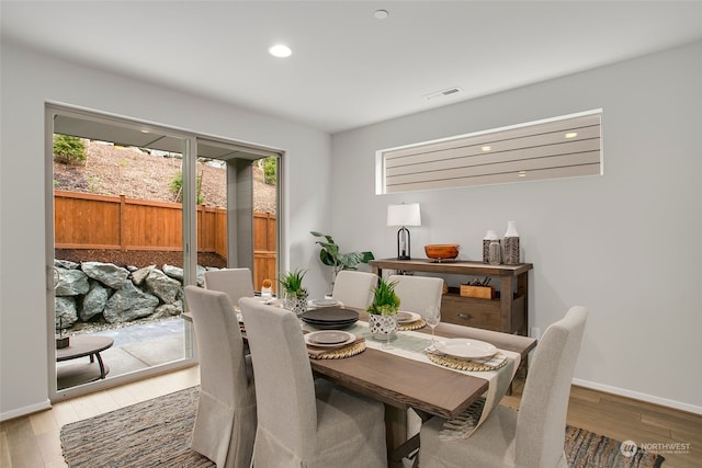 dining space with hardwood / wood-style flooring