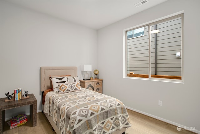 bedroom with hardwood / wood-style floors