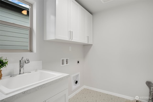 clothes washing area featuring sink, hookup for an electric dryer, light tile patterned floors, cabinets, and washer hookup