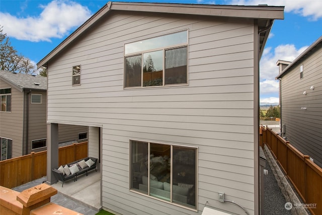 back of property with a patio and an outdoor hangout area