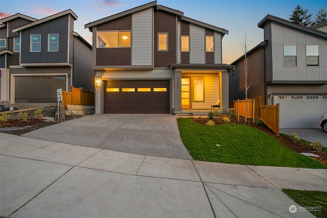 view of front facade featuring a lawn and a garage