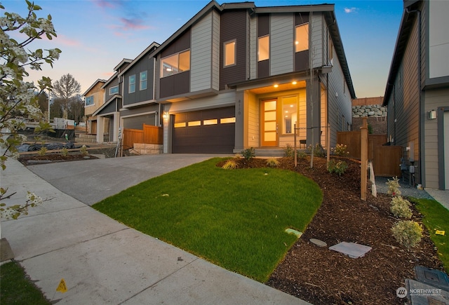 view of front of home with a garage and a yard