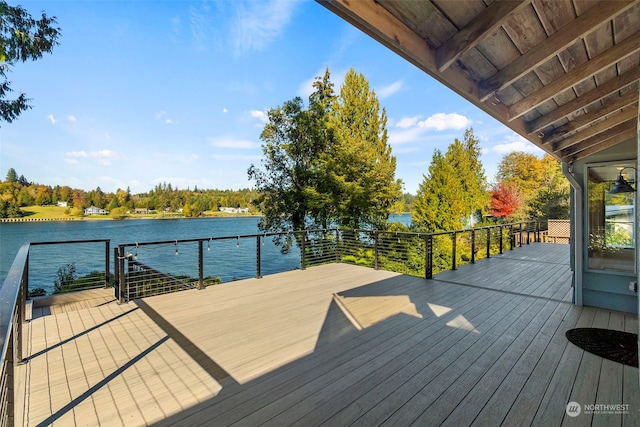 wooden deck featuring a water view