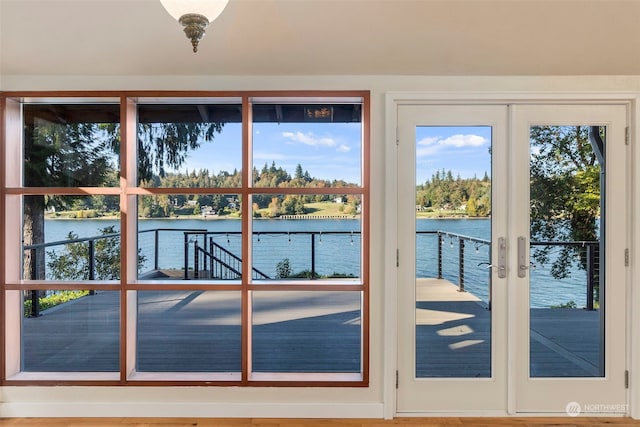 entryway with a water view, french doors, and hardwood / wood-style flooring