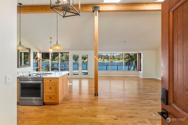 kitchen featuring beam ceiling, high vaulted ceiling, stainless steel range with electric cooktop, and light hardwood / wood-style floors