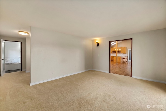 unfurnished room with light carpet