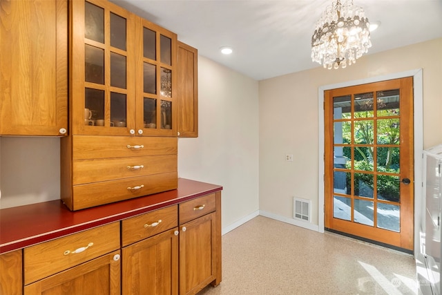 doorway with an inviting chandelier