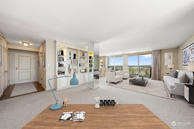 carpeted living room featuring crown molding