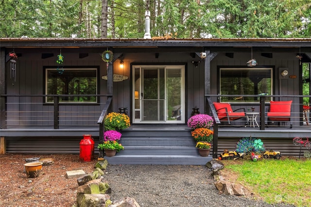 view of exterior entry with covered porch