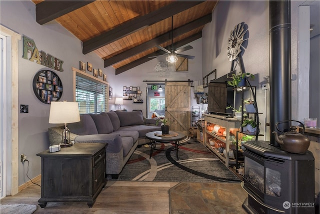 living room with wood ceiling, a barn door, ceiling fan, vaulted ceiling with beams, and hardwood / wood-style floors