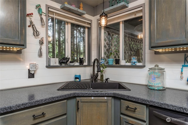 kitchen with dishwasher, sink, pendant lighting, and tasteful backsplash