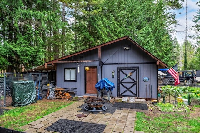 view of outbuilding featuring an outdoor fire pit