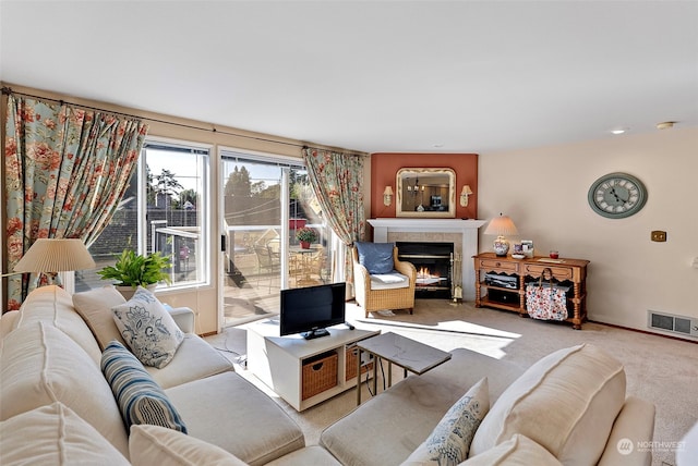 carpeted living room with a fireplace