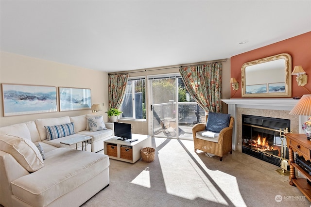 carpeted living room featuring a tiled fireplace