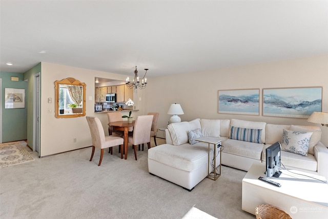 carpeted living room featuring an inviting chandelier