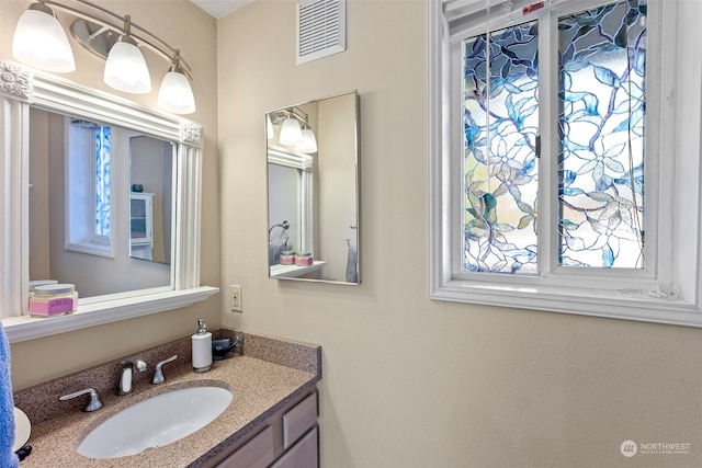 bathroom with vanity and a healthy amount of sunlight