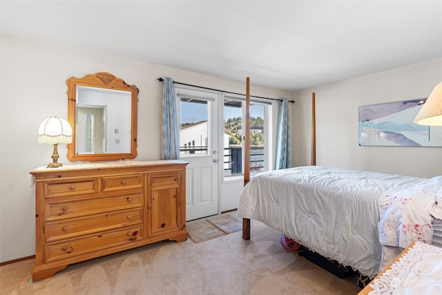 bedroom featuring light colored carpet and access to exterior