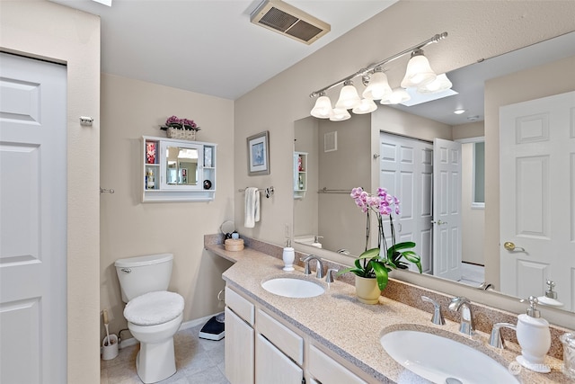 bathroom with tile patterned floors, vanity, and toilet