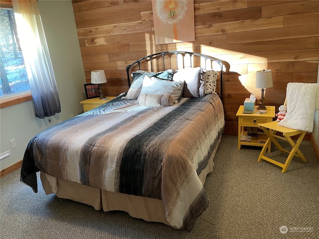 bedroom with carpet flooring and wooden walls