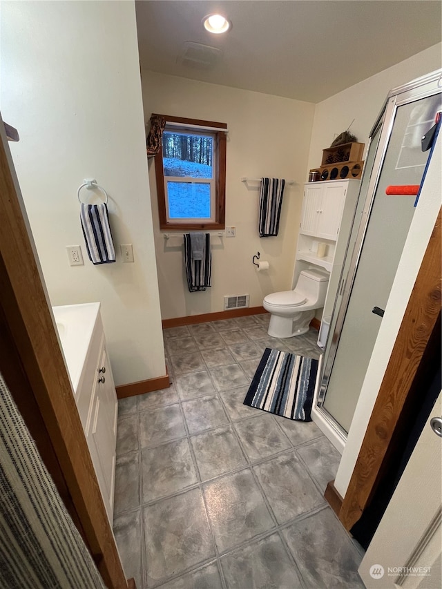 bathroom featuring walk in shower, tile patterned flooring, vanity, and toilet