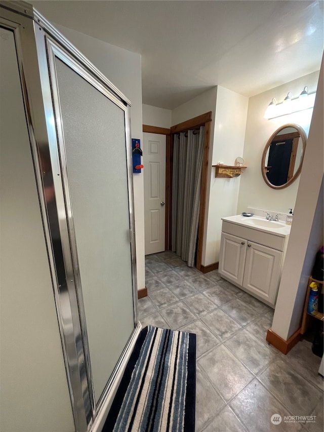 bathroom with vanity, tile patterned floors, and an enclosed shower