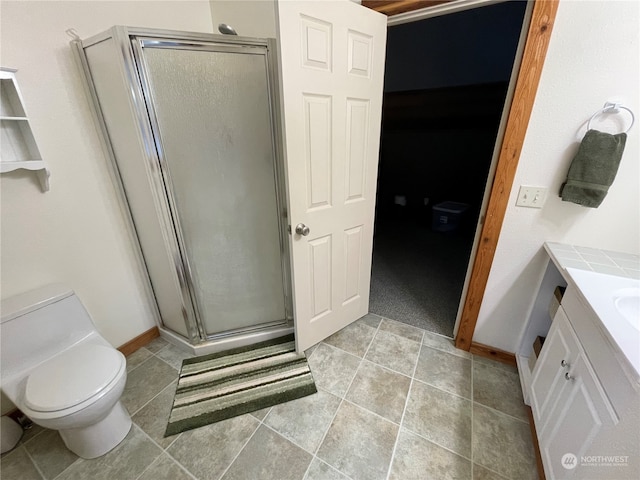 bathroom featuring vanity, tile patterned flooring, toilet, and an enclosed shower