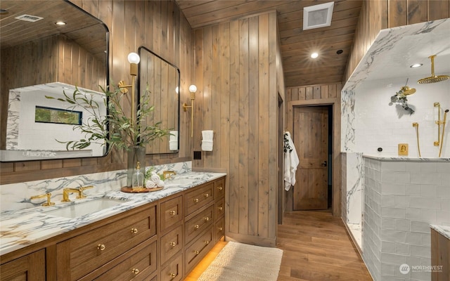 bathroom featuring backsplash, wood ceiling, vanity, wooden walls, and hardwood / wood-style flooring