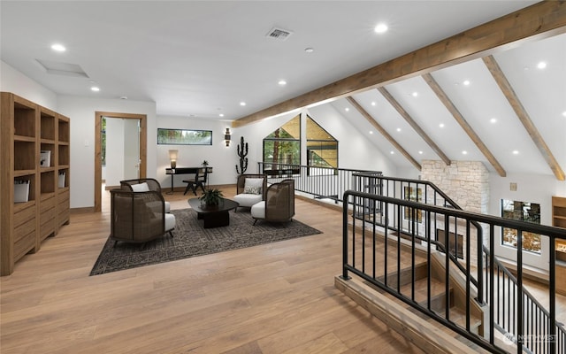 living room with light hardwood / wood-style flooring and lofted ceiling with beams